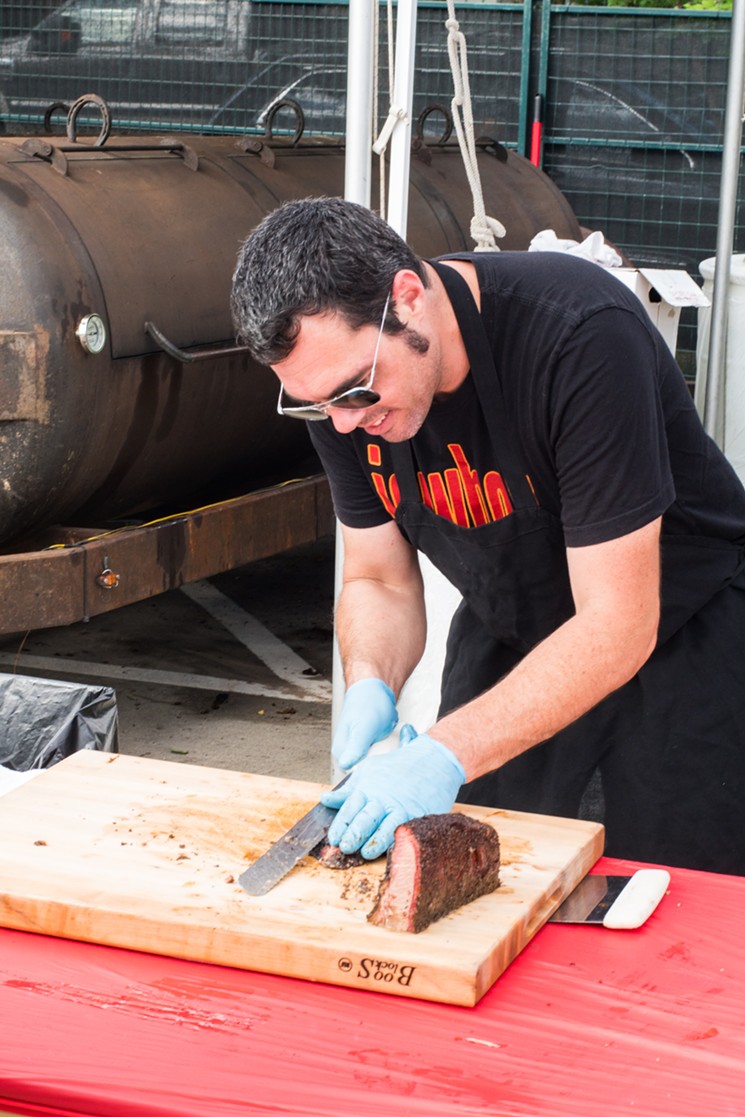 Aaron Franklin cranking out juicy slices of brisket at the Southern Smoke  Foundation Festival. - PHOTO BY ERIC HESTER
