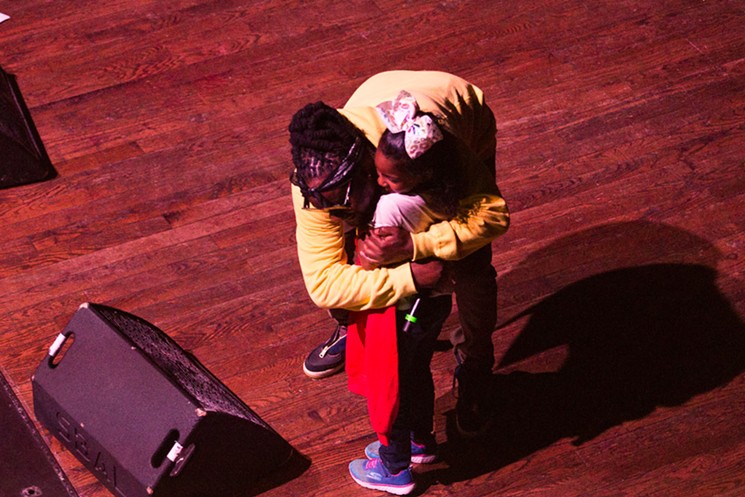 Wale hugging a fan after gifting her a hoodie. - PHOTO BY JENNIFER LAKE