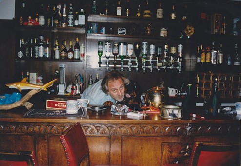 John Entwistle in Quarwood's fully-stocked basement bar with his rotweiler, Marlene. - PERSONAL PHOTO FROM THE ENTWISTLE ARCHIVE/COURTESY OF HACHETTE BOOKS