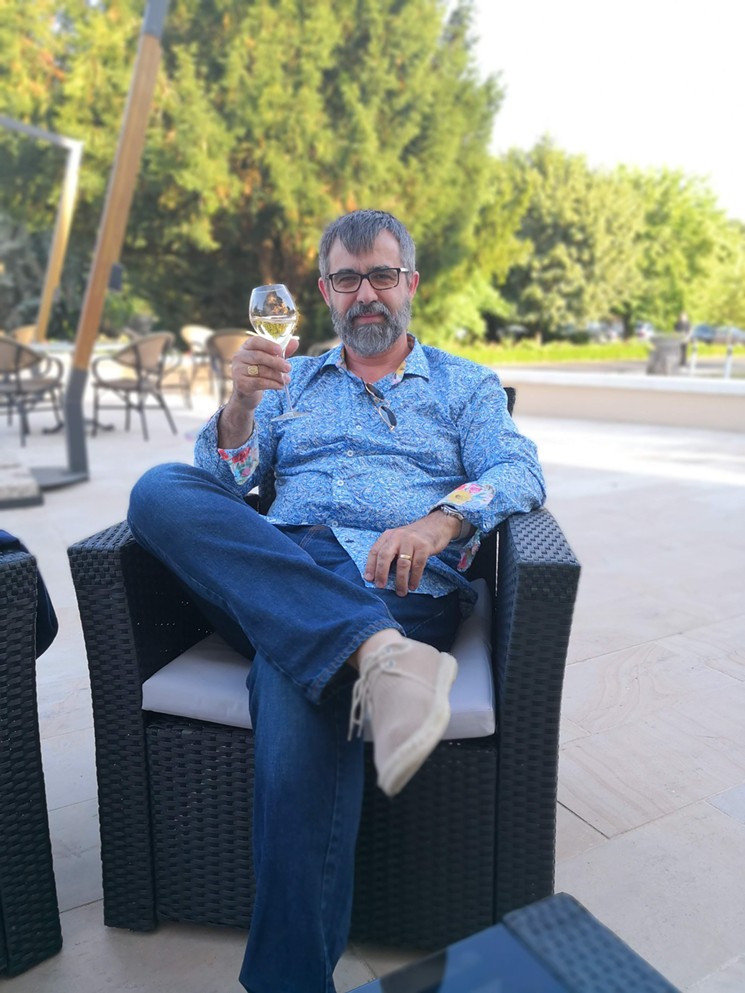 Jean-Philippe Guy, owner of French Country Wines, takes a break amid the craziness. - PHOTO BY GENEVIEVE GUY