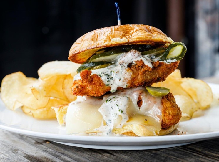 The Spicy Chicken Sandwich from Underbelly Hospitality is stacked high with flavor. - PHOTO BY JULIE SOEFER
