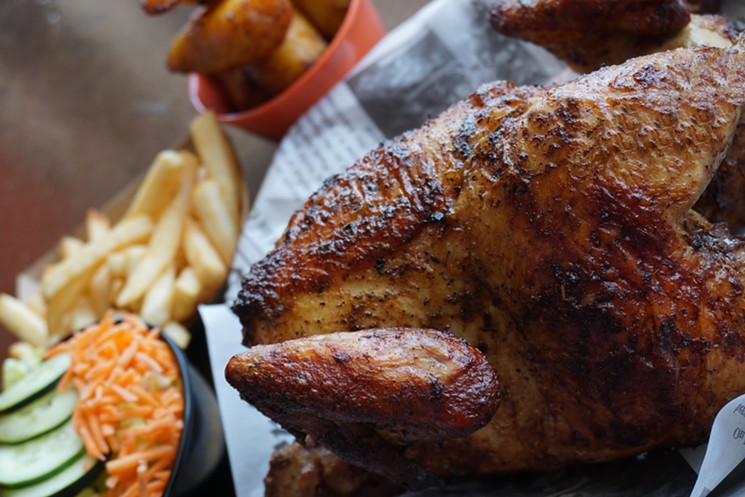 Peruvian rotisserie chicken is charcoal roasted at Chick Houzz. - PHOTO BY RITA CASTRE