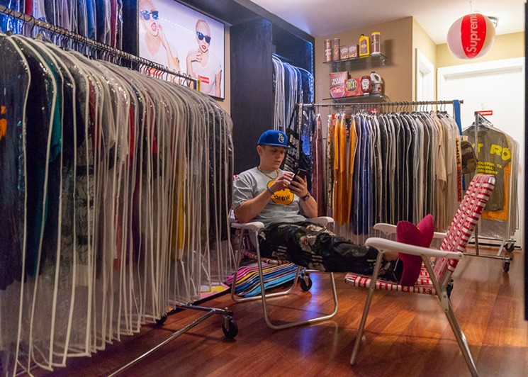 Michael Mills sits in the middle of his original Houston Closet. - PHOTO BY JENNIFER LAKE
