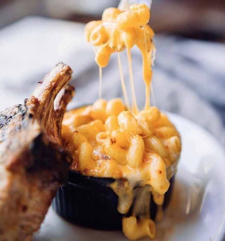 Gooey mac and cheese accompanies the Frenched  Pork Chop at Upper Kirby Bistro. - PHOTO BY SHELBY TSIKA MARQUARDT