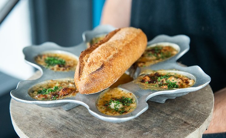 Dip up the oyster liquor with a fresh baguette. - PHOTO BY JACKLYN WARREN