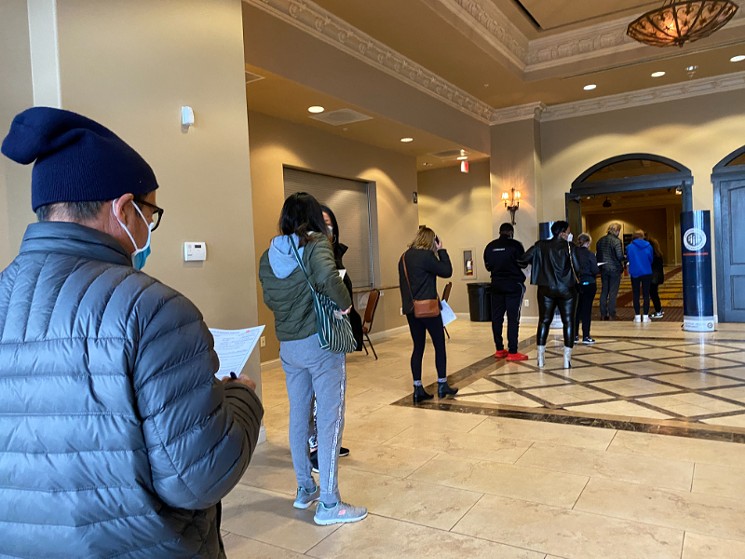 Local residents lined up inside the Bayou City Event Center Monday to get vaccinated by the Houston Health Department. - PHOTO BY SCHAEFER EDWARDS