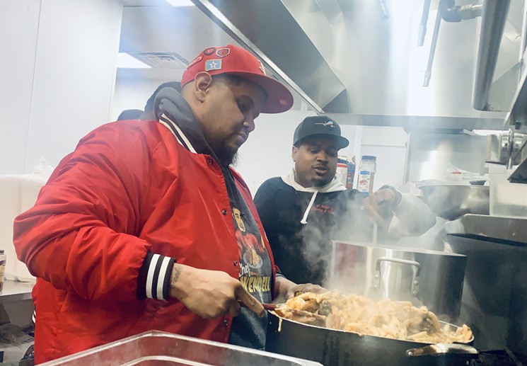 Wendell Debrain and Elmo Parker provide free plates of pasta and gumbo to hungry Houstonians. - PHOTO BY DEVAUGHN DOUGLAS