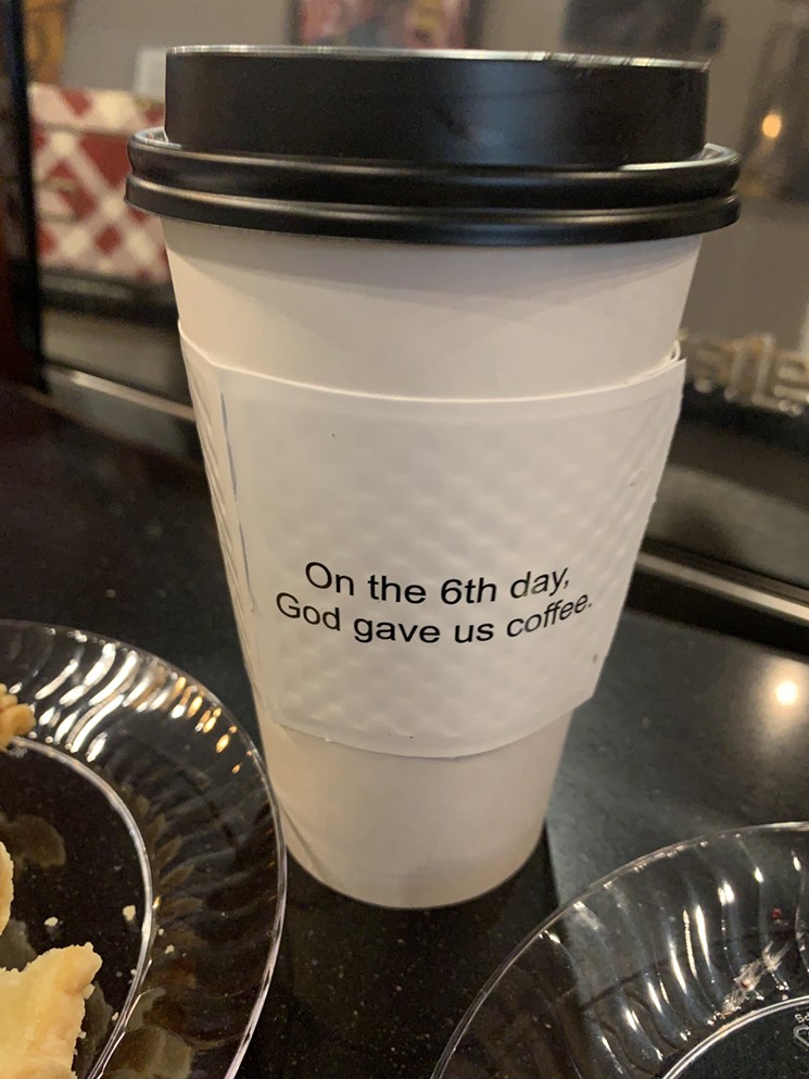 The verse that gave the brothers the idea for the store printed on their coffee cups. - PHOTO BY DEVAUGHN DOUGLAS