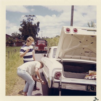 Friends and musical collaborators Jan Berry (standing) and future Beach Boy Bruce Johnston fix a flat tire. - PHOTO BY JILL GIBSON/COURTESY OF BOB MERLIS M.F.H.