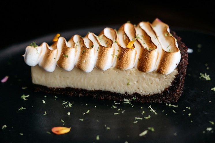 Pastry chef Alejandra Salas has created a handmade Key Lime Pie with a graham cracker crust topped with meringue and fresh lime zest for Bludorn's spring menu. - PHOTO BY CAROLINE FONTENOT