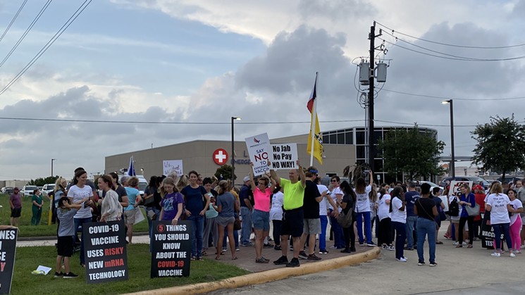 Anti-vaccine locals gathered to protest across from Houston Methodist's Baytown hospital as passers-by honked in support. - PHOTO BY SCHAEFER EDWARDS
