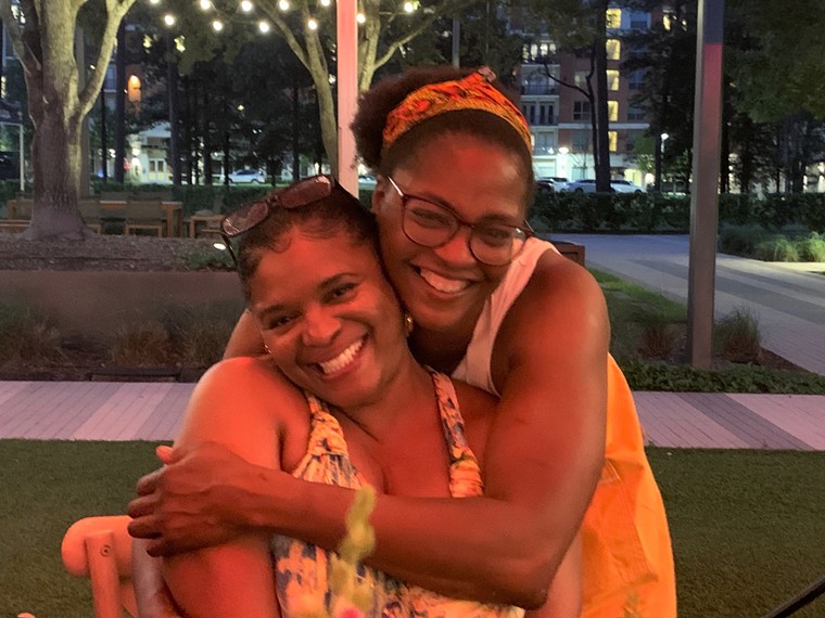 Chef Burrell hugs her sister Valerie after teaching her class.  - PHOTOGRAPH BY LORRETTA RUGGIERO