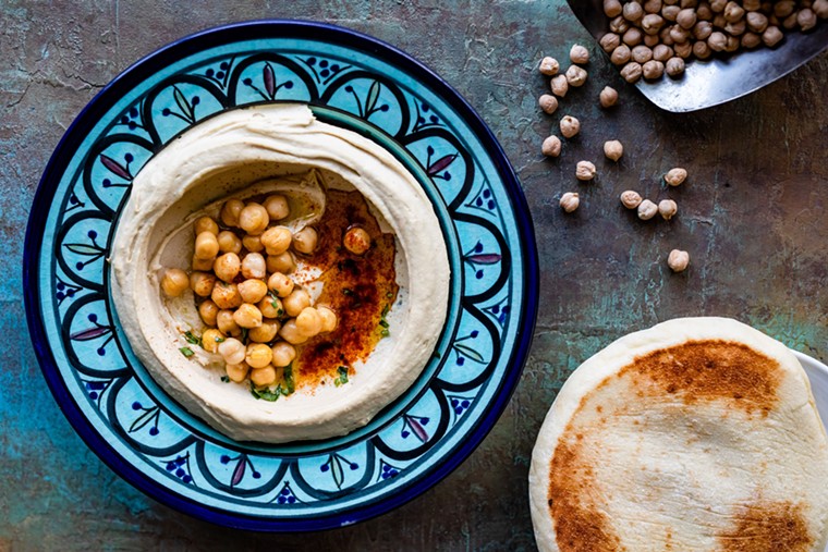 The delicious chickpea hummus is accompanied by brick oven-baked pita. - PHOTO BY KIRSTEN GILLIAM