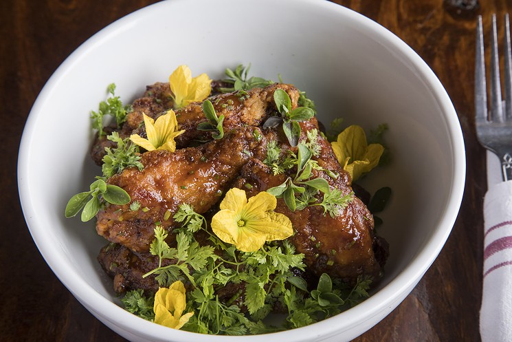 The chicken wings were fried to a crisp and glazed in an Asian-style sweet and spicy sauce. - PHOTO BY TROY FIELDS