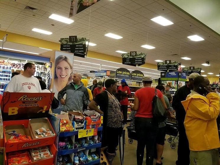 Residents of Missouri City line up at their neighborhood Kroger on Monday. - PHOTO BY MARGARET DOWNING