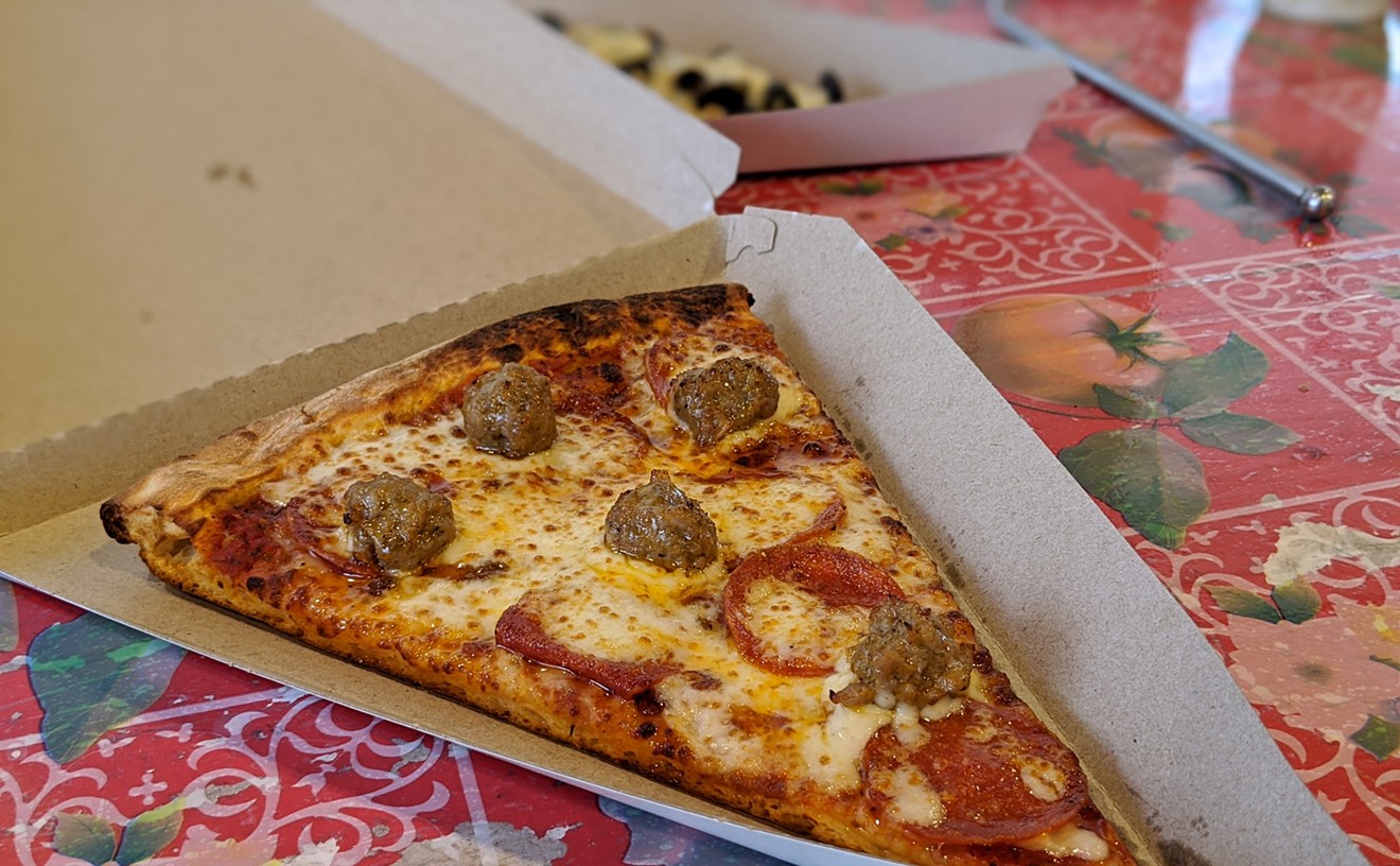 A slice of pepperoni and Italian sausage from Pink's Pizza.