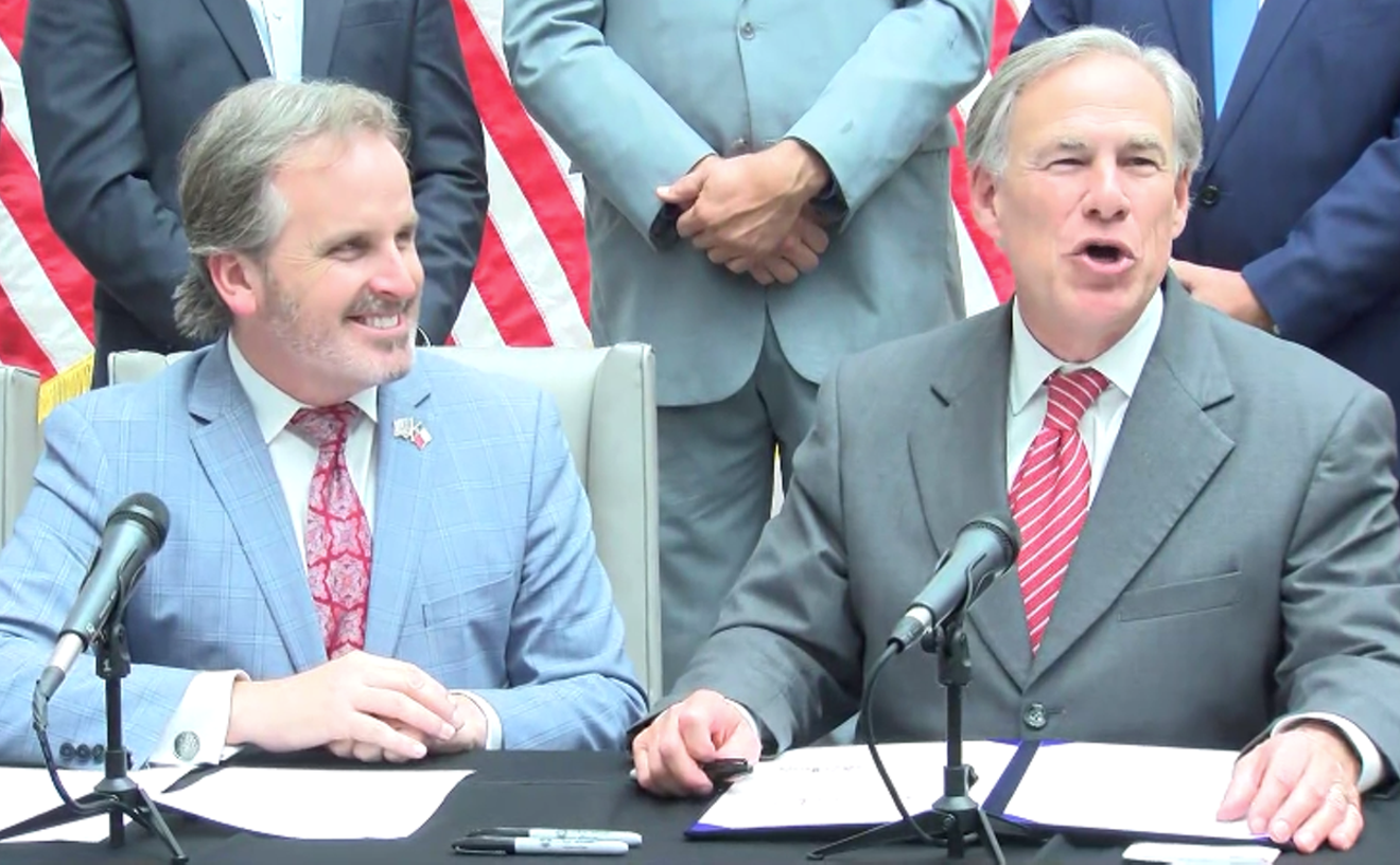 State Sen. Bryan Hughes and Gov. Greg Abbott on the September day the governor signed the "election integrity" bill into law.