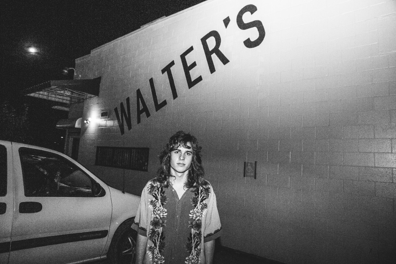 Spencer Fort of the band Moth Wings stands in front of Walter's for the last time.