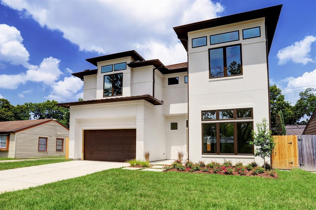 This modern contemporary home at 1718 Ebony Lane in Oak Forest East features huge picture windows and 12 foot ceilings.