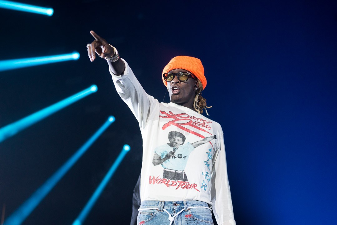 Young Thug points at a screaming fan trying to get his attention.